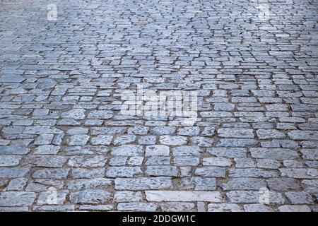 Old stone marble paved footpath, cobblestone background, texture. Pathway to Acropolis rock. Perspective high angle view. Stock Photo