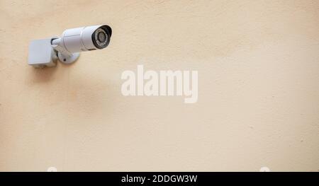 Security Camera CCTV isolated on beige color wall background, copy space Stock Photo