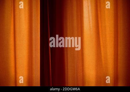 Behind closed curtains, wrinkled window blinds as background Stock Photo