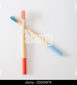Pink and blue bamboo toothbrushes isolated on white background. Eco friendly, zero waste, plastic free concept. Kids personal hygiene, template Stock Photo