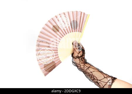 A closeup shot of a woman's hand in a lace glove holding a fan isolated on a white background Stock Photo