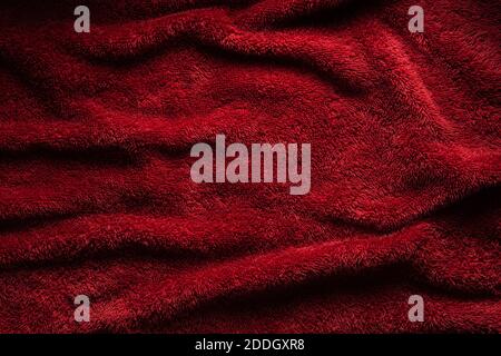 A soft red terry towel. Burgundy texture background. Underlay and free space for text. Stock Photo