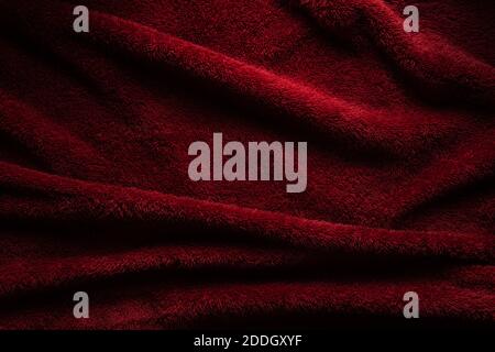 A soft red terry towel. Burgundy texture background. Underlay and free space for text. Stock Photo