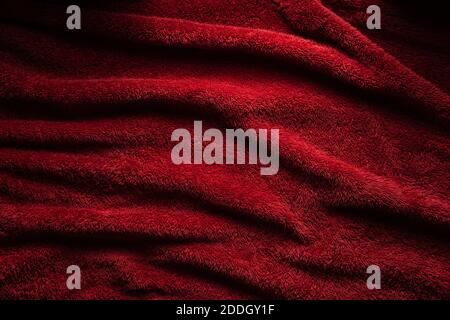 A soft red terry towel. Burgundy texture background. Underlay and free space for text. Stock Photo