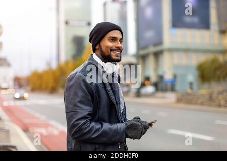 Handsome young man using mobile phone at the street Stock Photo