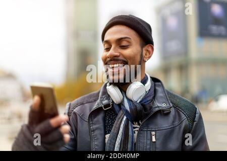 Handsome young man using mobile phone at the street Stock Photo