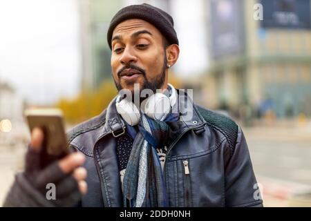 Handsome young man using mobile phone at the street Stock Photo