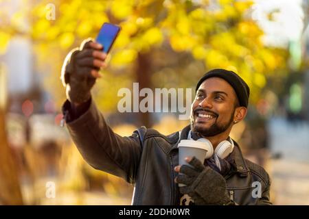Handsome young man using mobile phone at the street Stock Photo