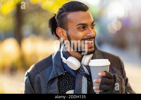Handsome young young man drinking coffee in the street Stock Photo