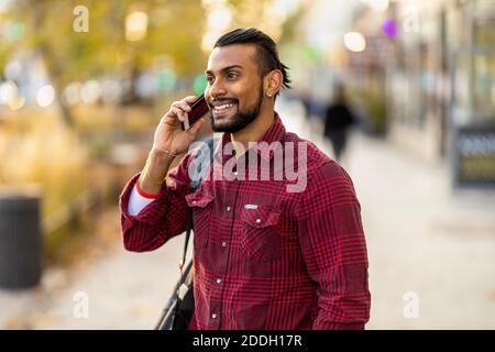 Handsome young man using mobile phone at the street Stock Photo