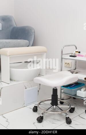 Interior of white modern manicure salon without people. Luxury work places for masters of pedicure Stock Photo