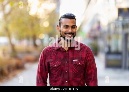 Portrait of a handsome young man on the city street Stock Photo