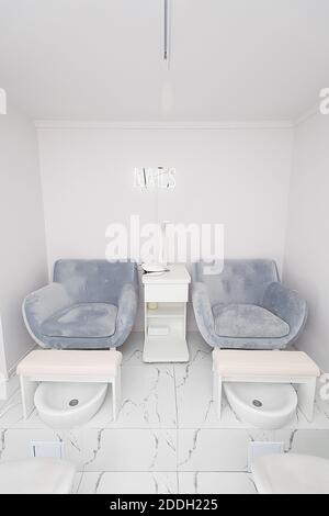 Interior of modern manicure salon without people. Luxury work places for masters of pedicure Stock Photo