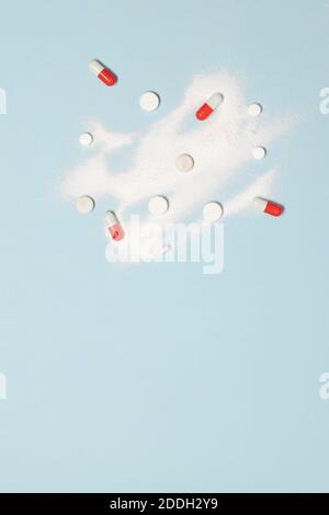 Medical preparations powder or capsules of different colors on a blue background. Vertical photo. Healthy lifestyle concept. Place for text Stock Photo