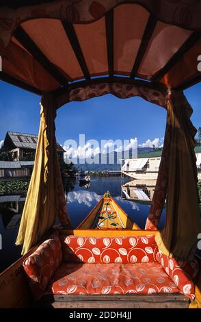 19.08.2010, Srinagar, Jammu and Kashmir, India, Asia - A traditional wooden Shikara boat with its typical drapes and baldachin crosses the Dal Lake. Stock Photo