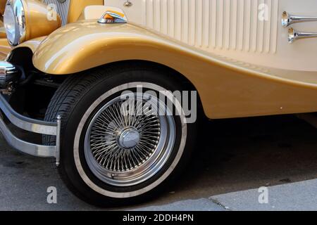 Wheel and a fragment of the front end of a vintage car. Stock Photo