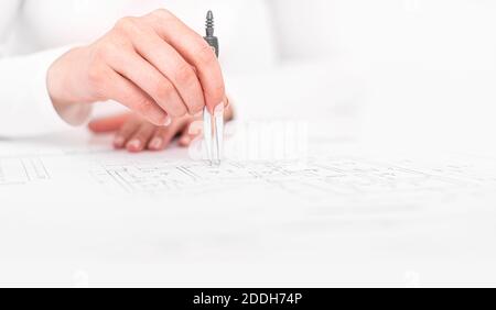 An engineer works with drawings. A person draws sketches or plans Stock Photo