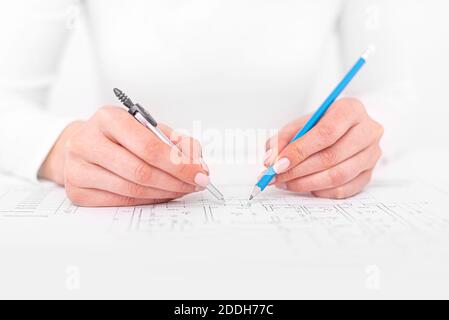 An engineer works with drawings. A person draws sketches or plans Stock Photo