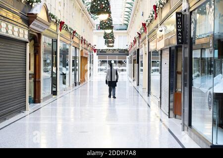 Glasgow, Scotland, UK. 25 November 2020. Glasgow city centre  very quiet during severe level 4 lockdown imposed by the Scottish Government.  Non essential businesses , bars, restaurants and shops are closed. Pictured; Concierge inside and empty Argyll Arcade. Credit.  Iain Masterton Stock Photo