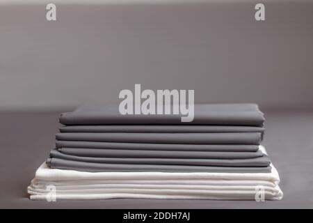 A stack of folded clean gray and white sheets. Stock Photo