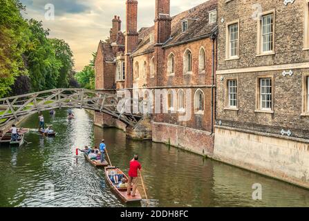 Students are punting on the River Cam of the medieval university city of Cambridge, England