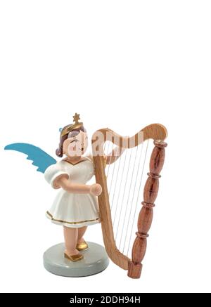 Closeup of a original handcarved wooden German Christmas Angel figurine playing a harp cut out on a white background Stock Photo