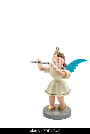 Closeup of a original handcarved wooden German Christmas Angel figurines with a flute cut out on a white background Stock Photo