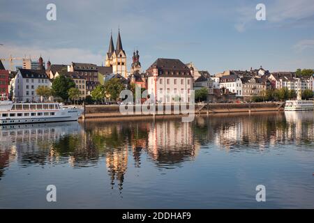 The River Rhine near Cochem in Germany and buildings of a town on the river bank reflected in the calm waters of the river Stock Photo