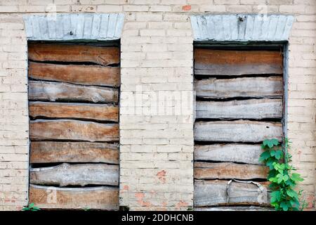 Boarded up window openings, weathered plank texture, close-up, image with copy space. Stock Photo