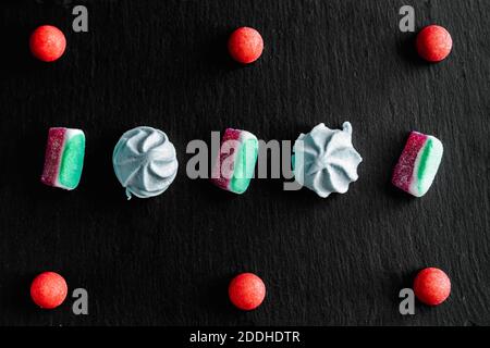 Sweets colorful candies, marmalade and marshmallow organized pattern top view. Stock Photo