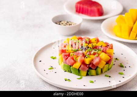 Tuna mango avocado salad tartare served with green onions and sesame seeds. Stock Photo