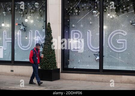 London, UK, 25 November 2020: Shops in London are shut and Harvey Nichols has neon window displays saying BAH HUMBUG and BRING ON 2021. London Mayor Sadiq Khan has said he wants London to be in Tier 2 of the post-lockdown restrictions.  Anna Watson/Alamy Live News Stock Photo