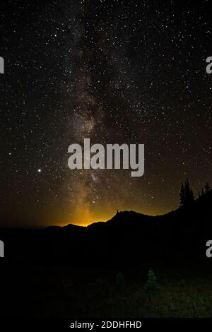 WA18542-00...WASHINGTON - The Milkyway and lights of the Puget Sound Basin viewed from Goat Lake Basin located on the PCT in the Pasayten Wilderness a Stock Photo