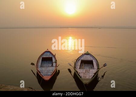 Two empty boats on the Ganges river near ghats on sunset time, Varanasi, India Stock Photo