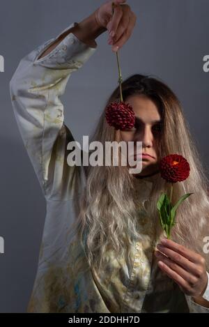 Smiling girl covering eyes with chamomile flowers Stock Photo - Alamy
