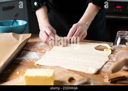 Women preparing homemade food pie, pizza in a cozzy kitchen. Hobbies and family life concept. Stock Photo