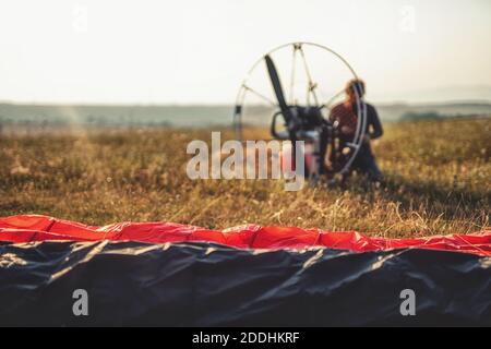 Paragliding in the mountains, paraglider on the ground. Stock Photo