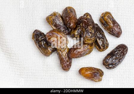 Dried dates on white cloth - top view image with copy space Stock Photo