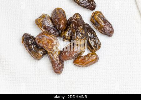 Dried dates on white cloth - top view image with copy space Stock Photo