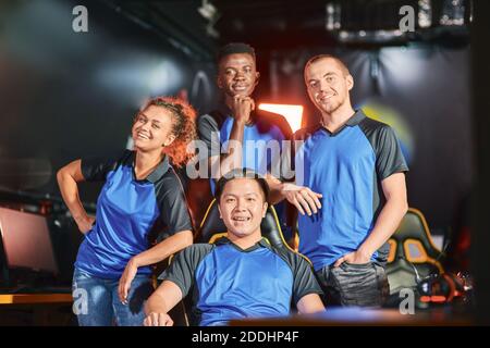 Professional gamers. Happy multiracial cybersport team smiling at camera after eSport tournament. Online video games competition Stock Photo