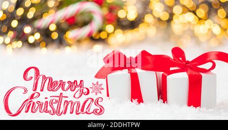 Greeting card for Merry Christmas with two gift boxes with red ribbon the snow Stock Photo