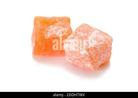 Turkish delight. Pomegranate rahat locum, two pieces of of sweet oriental delights in powered sugar, close-up view. Stock Photo