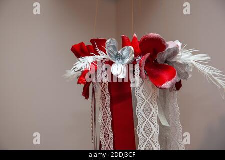 a decorative holiday christmas chandelier made of fabric and flowers Stock Photo