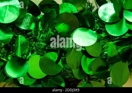 Tiny shining green flakes on a green christmas wreath make an abstract background Stock Photo