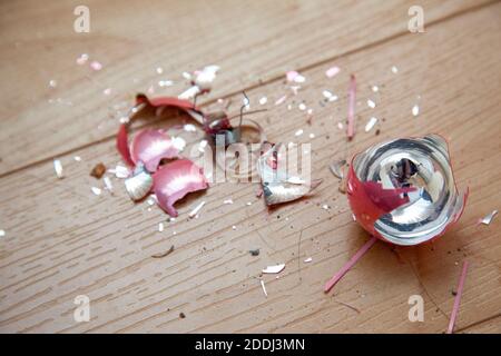 pink shattered glass christmas ball on the ground after breaking Stock Photo