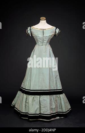 Two-piece Evening Dress, 1868, Taffeta two-piece dress with velvet ribbon and lace trim. The skirt has a train Stock Photo