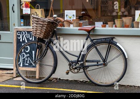 a vintage bicycle with a wicker basket on the front Stock Photo Alamy