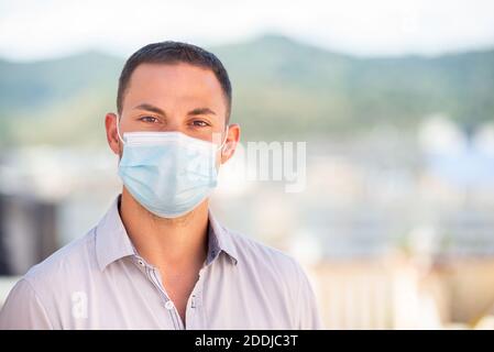 Young man wearing a coronavirus protection mask Stock Photo