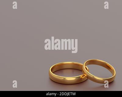 Two wedding gold rings lie next to each other on grey background. 3d rendering Stock Photo