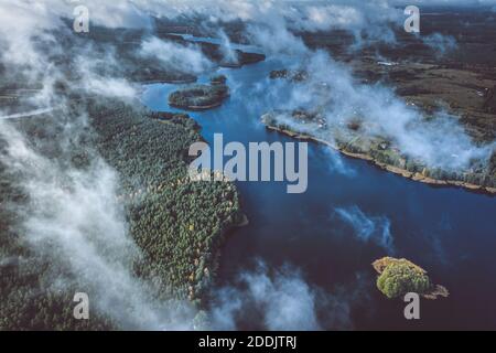 Aerial view of lake and clouds below Stock Photo